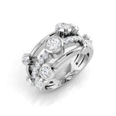 A wide, multi-band diamond wave ring in platinum or white gold, featuring a central river of pavé diamonds and scattered bezel-set diamonds, on a white background.